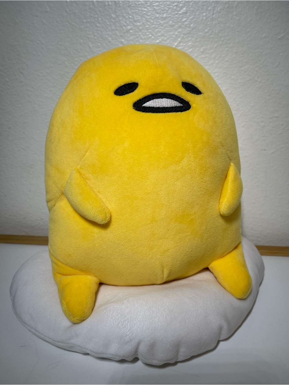 Gudetama Yellow Plush Sitting on Egg White Pillow